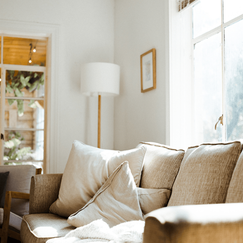 a living room with a couch and a lamp